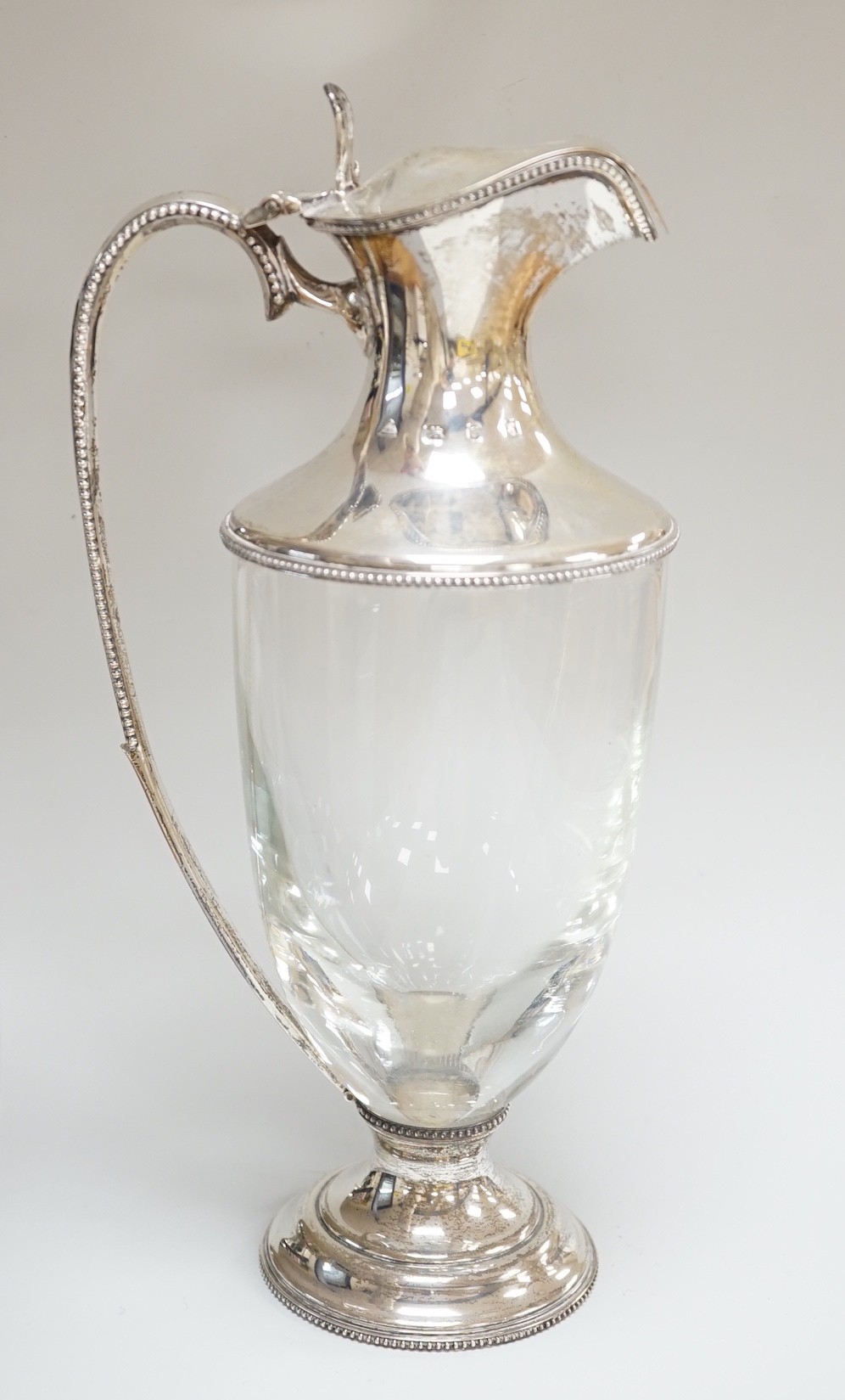 A modern silver mounted glass urn shaped claret jug, on pedestal foot, J A Campbell, London, 1981, 27.2cm.